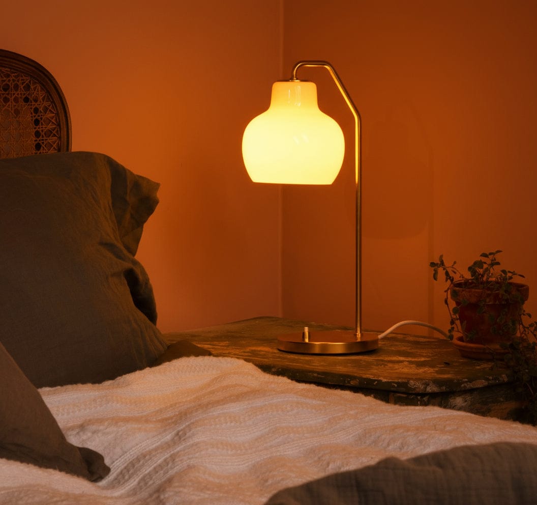 Lamp on a bedside table with warm Amber lighting in a bedroom setting