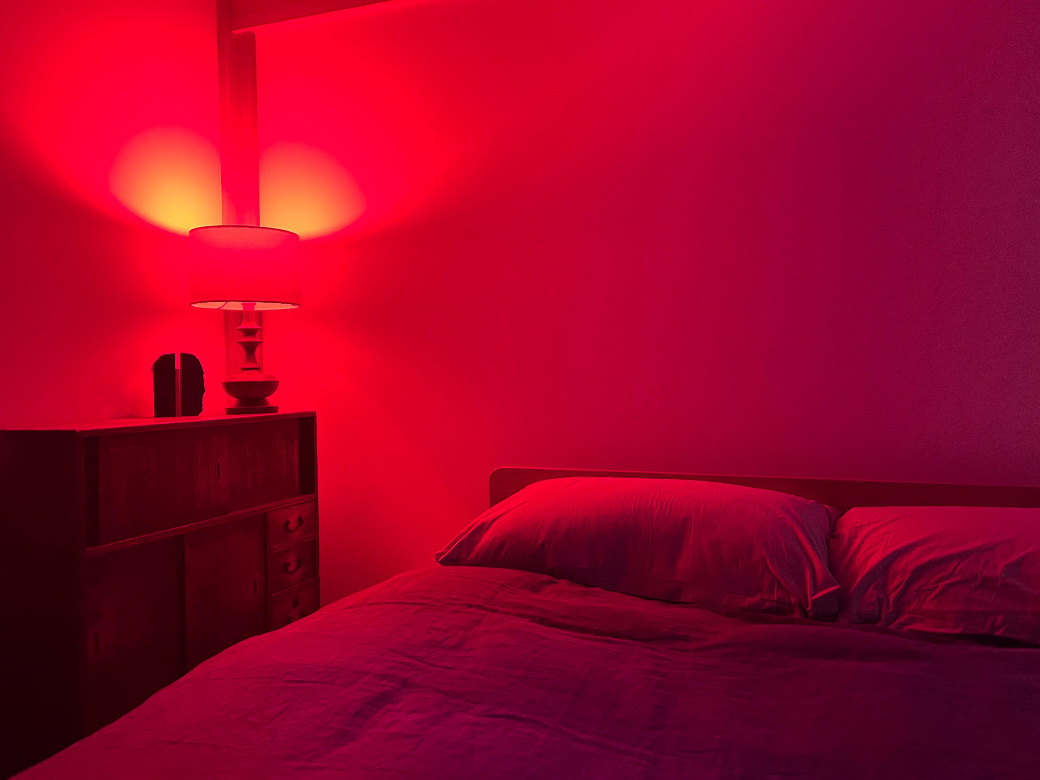 Red light bulb for sleep beside bed at night